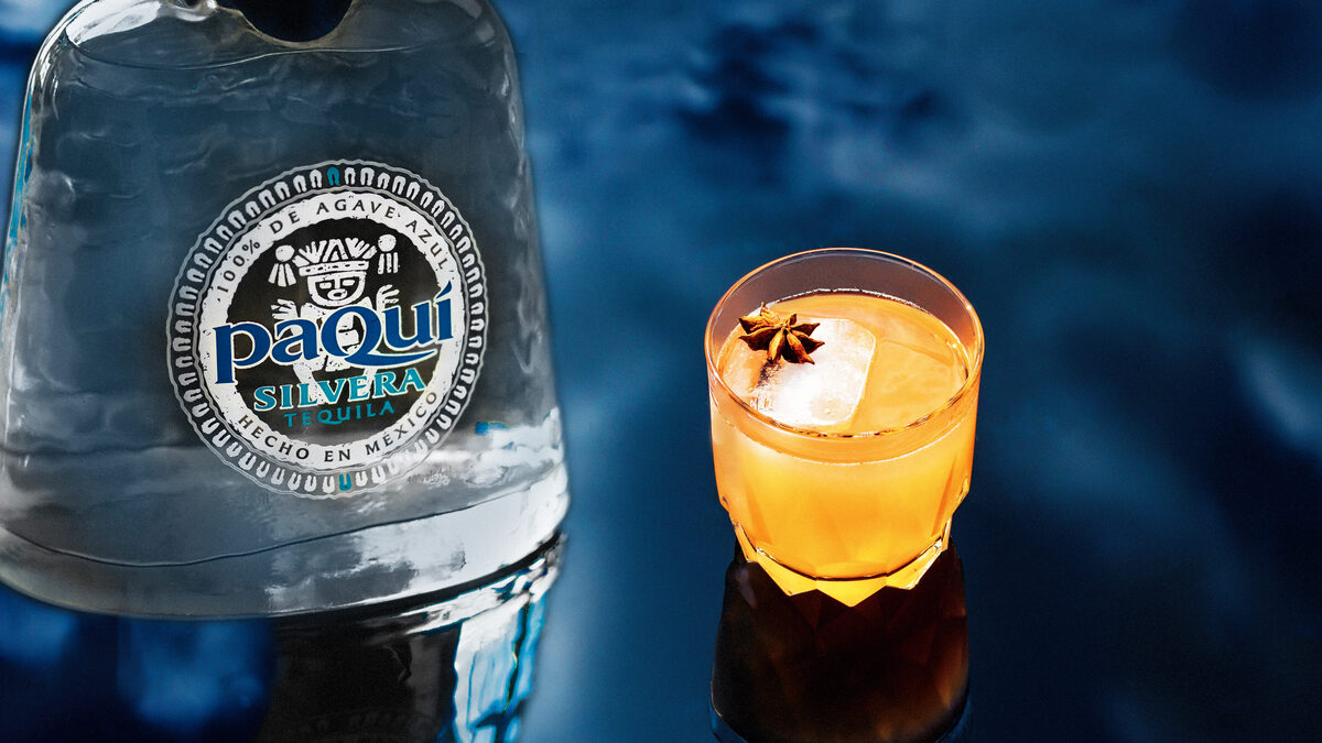 PaQui Tequila cocktail with star anise garnish and dramatic blue lighting